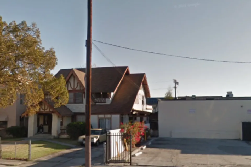 Google street view of late Victorian home in Harvard Heights neighborhood of Los Angeles, with one-story commercial building next door.